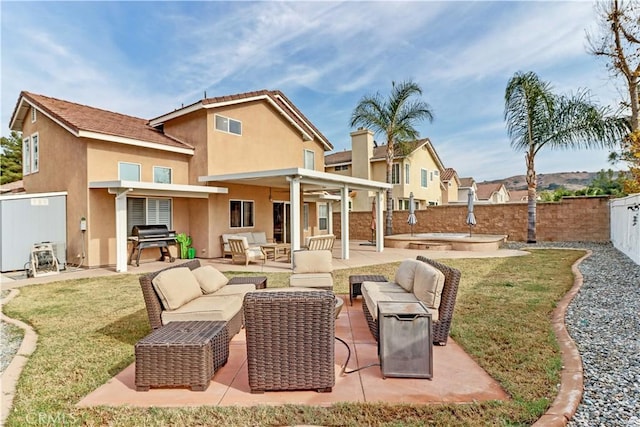 rear view of house with a patio area, a yard, an outdoor living space, and ceiling fan