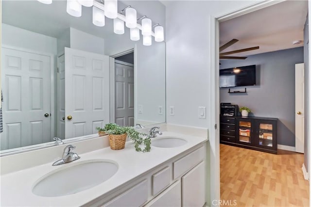 bathroom featuring ceiling fan, wood-type flooring, and vanity