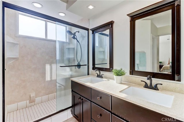 bathroom featuring vanity, tile patterned floors, and tiled shower