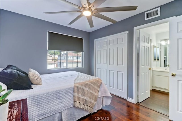 bedroom with ceiling fan, a closet, dark hardwood / wood-style floors, and connected bathroom