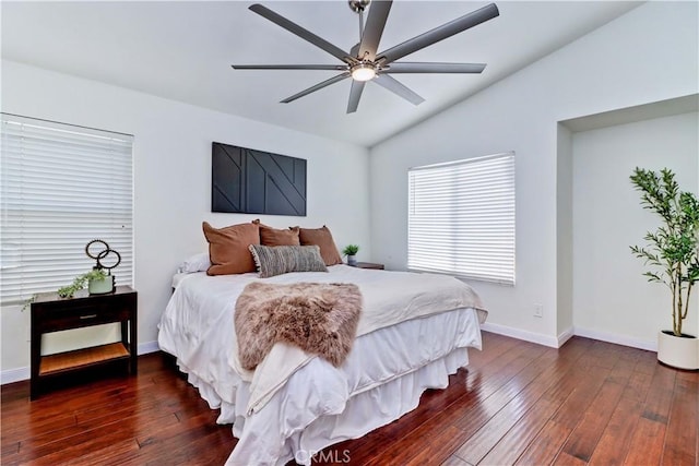 bedroom featuring ceiling fan, dark wood-type flooring, and lofted ceiling