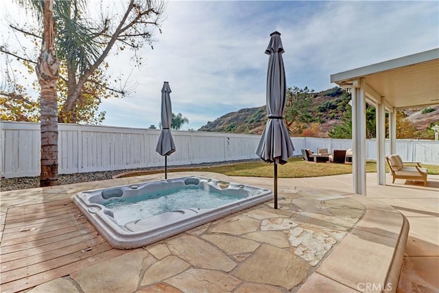 view of swimming pool with a mountain view, an outdoor living space, and a patio