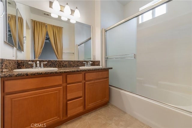 bathroom featuring bath / shower combo with glass door, tile patterned flooring, and vanity