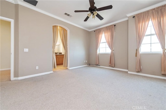 carpeted spare room featuring ceiling fan and crown molding