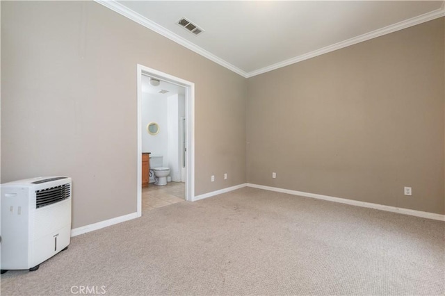 carpeted spare room featuring ornamental molding