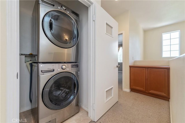 laundry room with stacked washer and clothes dryer