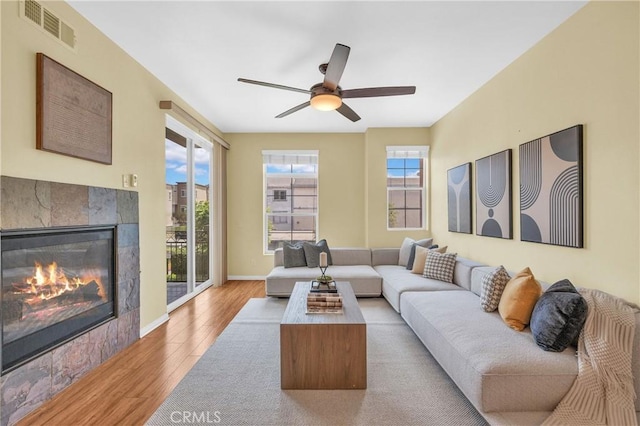 13637 Foster Ave Unit 5, Baldwin Park, CA 91706 - living area with wood finished floors, a fireplace, a ceiling fan, and baseboards