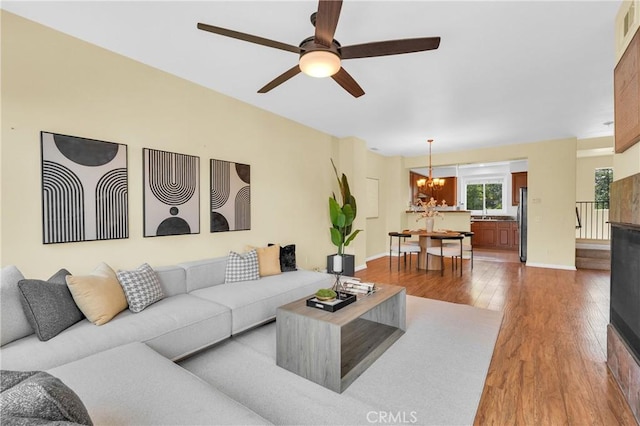 13637 Foster Ave Unit 5, Baldwin Park, CA 91706 - living room featuring a chandelier, wood finished floors, a ceiling fan, and baseboards