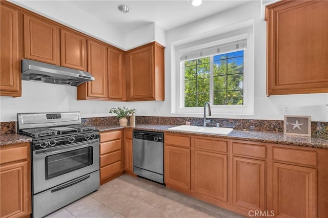 13637 Foster Ave Unit 5, Baldwin Park, CA 91706 - kitchen with appliances with stainless steel finishes, under cabinet range hood, a sink, dark stone counters, and brown cabinets