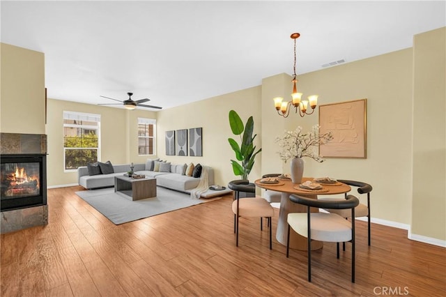 13637 Foster Ave Unit 5, Baldwin Park, CA 91706 - living area with wood finished floors, a chandelier, a multi sided fireplace, and baseboards