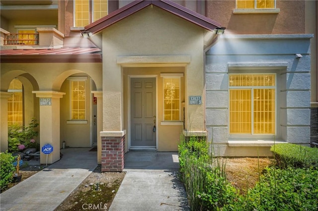 13637 Foster Ave Unit 5, Baldwin Park, CA 91706 - view of exterior entry featuring a standing seam roof, stucco siding, and metal roof