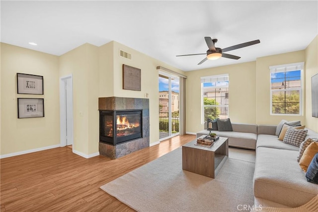 13637 Foster Ave Unit 5, Baldwin Park, CA 91706 - living area featuring light wood-style floors, a fireplace, baseboards, and a ceiling fan
