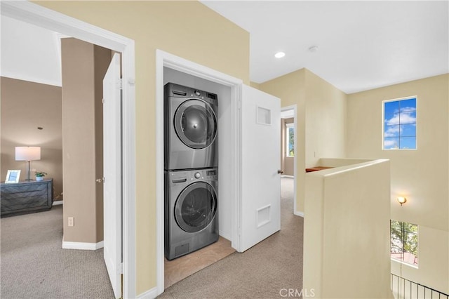 13637 Foster Ave Unit 5, Baldwin Park, CA 91706 - laundry area featuring stacked washing machine and dryer, carpet floors, and baseboards