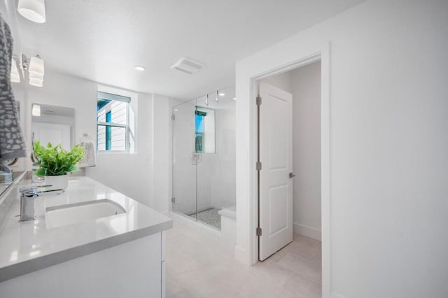 bathroom with walk in shower and vanity