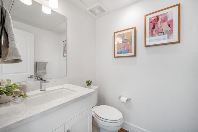 bathroom featuring toilet and vanity