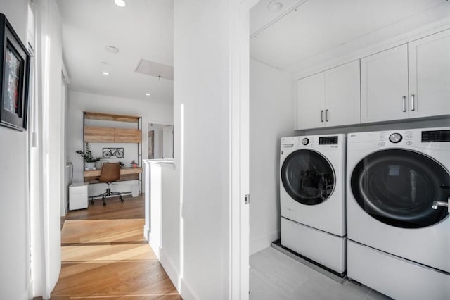 laundry area with washer and dryer and cabinets