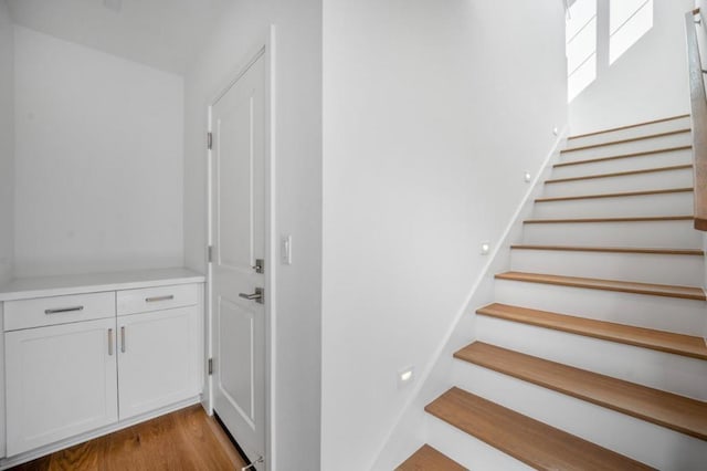 stairs featuring wood-type flooring