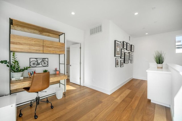 office space with light wood-type flooring