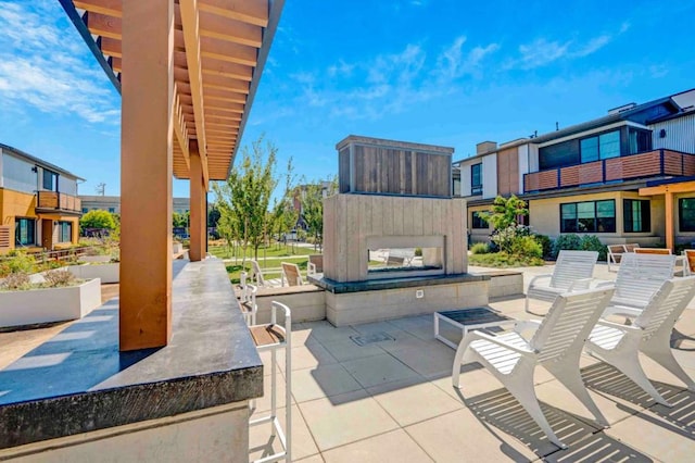 view of patio featuring a fireplace