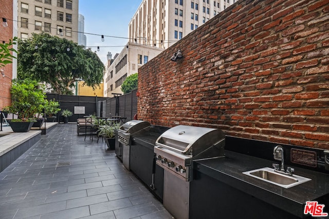 view of patio / terrace with sink, a grill, and area for grilling