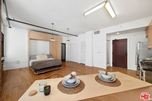 bedroom with light hardwood / wood-style flooring