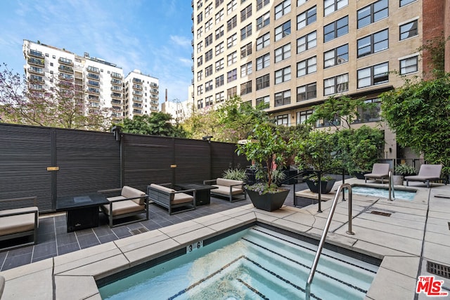 view of pool with a patio and a community hot tub