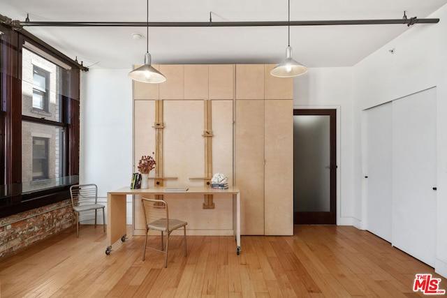 kitchen featuring light hardwood / wood-style floors and pendant lighting