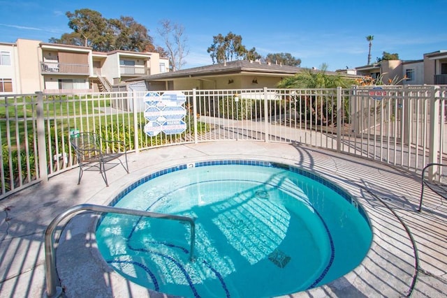 view of swimming pool with a community hot tub