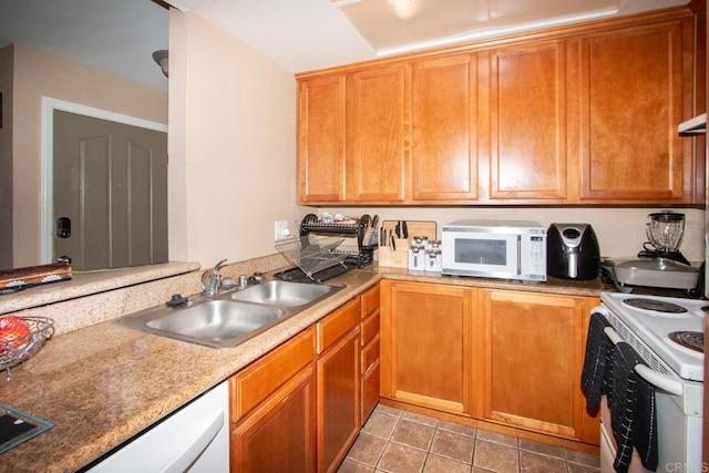 kitchen featuring tile patterned flooring, sink, and white appliances