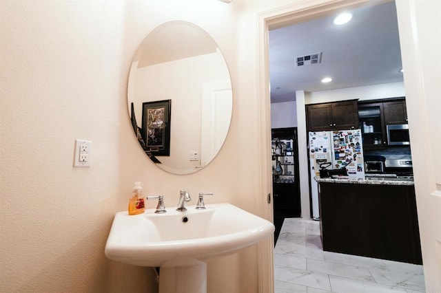 bathroom with decorative backsplash and sink