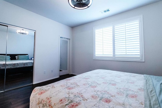 bedroom featuring a closet and dark hardwood / wood-style flooring