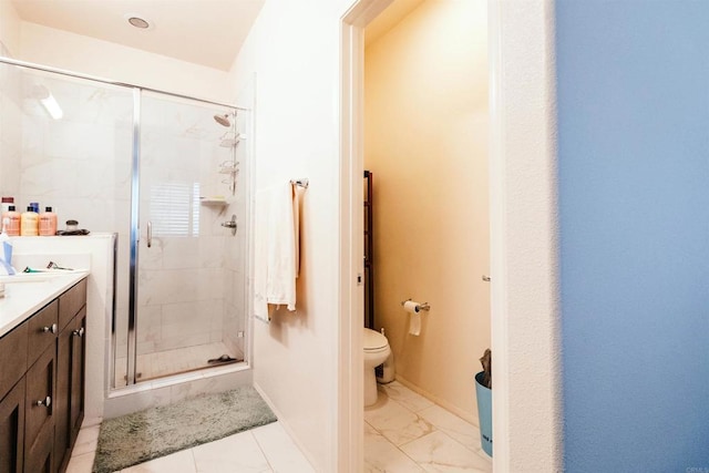 bathroom featuring toilet, vanity, and an enclosed shower