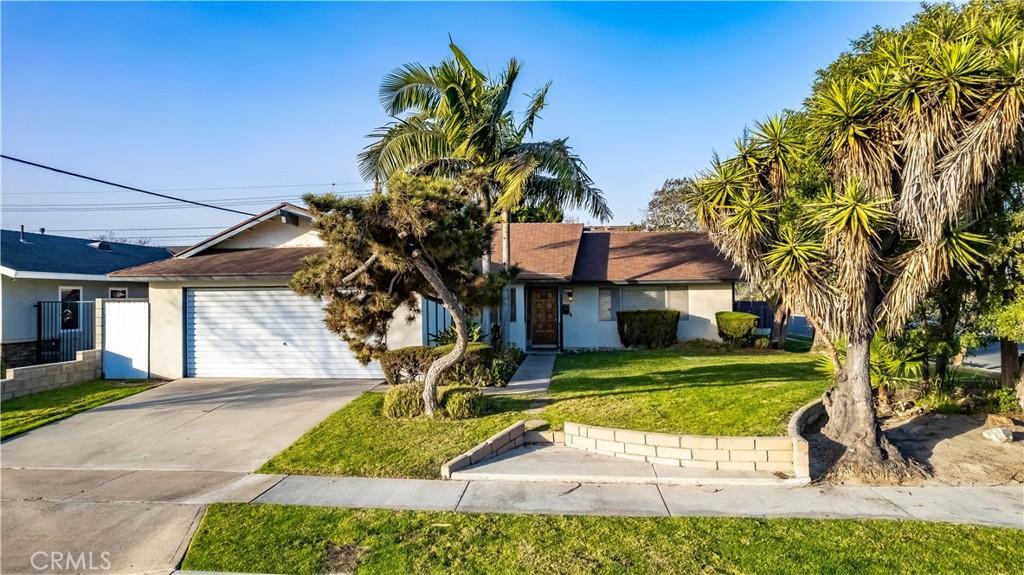 ranch-style house with a garage and a front yard