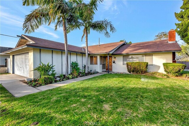 ranch-style home featuring a front yard and a garage