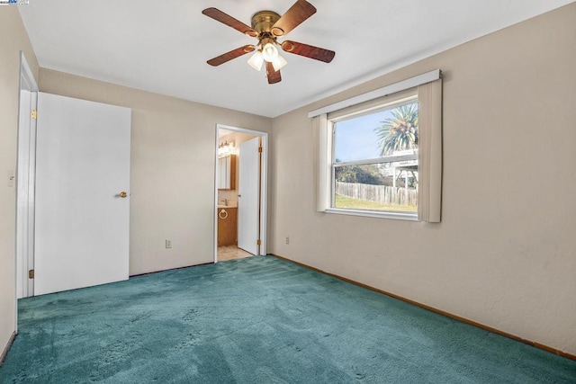 unfurnished bedroom with ceiling fan, light colored carpet, and ensuite bath