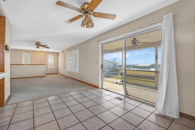 interior space with light carpet and ceiling fan