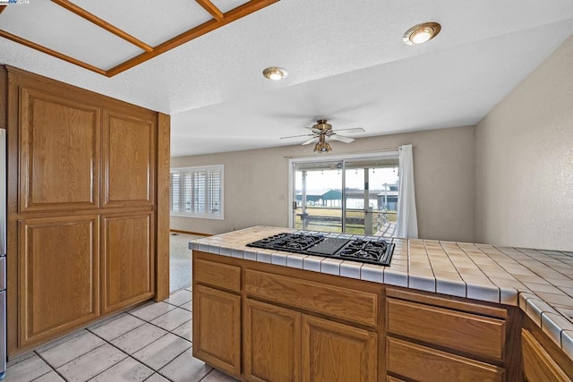 kitchen featuring plenty of natural light, tile countertops, and black gas cooktop