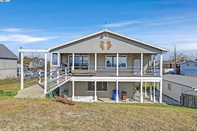 rear view of house featuring a yard and a patio area