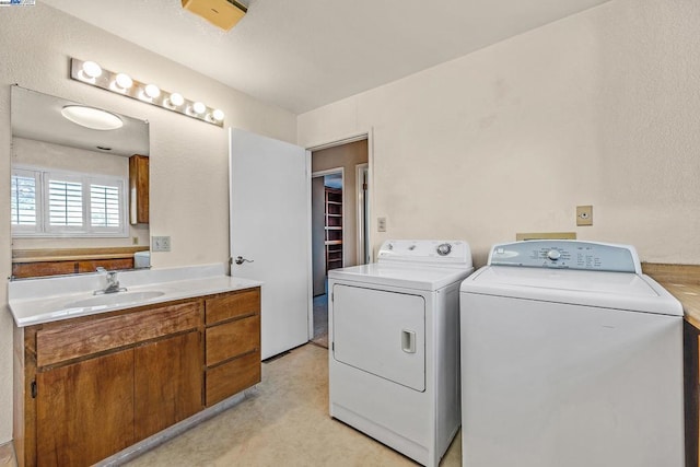 clothes washing area featuring sink and independent washer and dryer