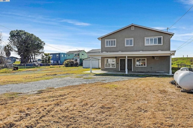 rear view of property with a yard