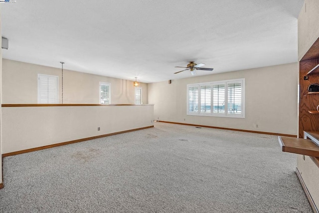 spare room with ceiling fan and carpet flooring