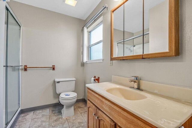 bathroom featuring an enclosed shower, vanity, tile patterned flooring, and toilet