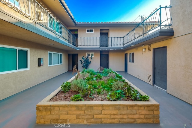 view of exterior entry featuring a balcony