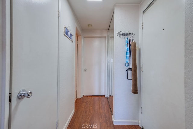 corridor with light hardwood / wood-style floors