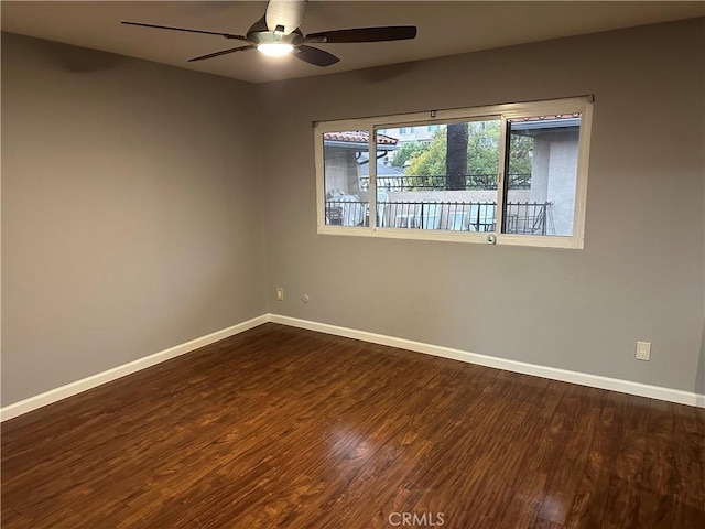 empty room featuring ceiling fan and dark hardwood / wood-style flooring