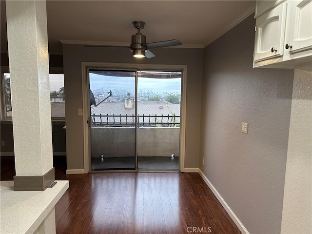 unfurnished dining area featuring crown molding, ceiling fan, and dark hardwood / wood-style flooring