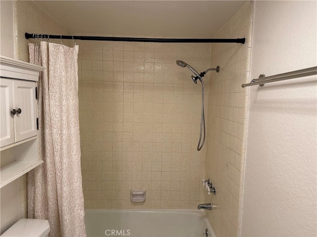 bathroom featuring shower / bath combo with shower curtain