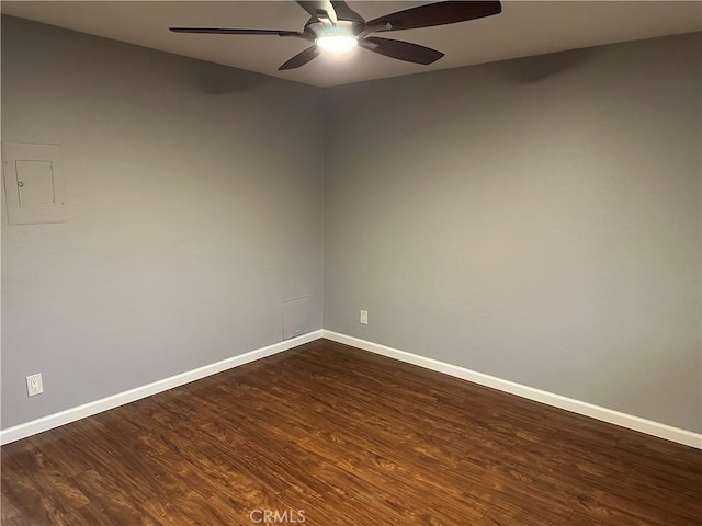 unfurnished room featuring dark wood-type flooring and ceiling fan