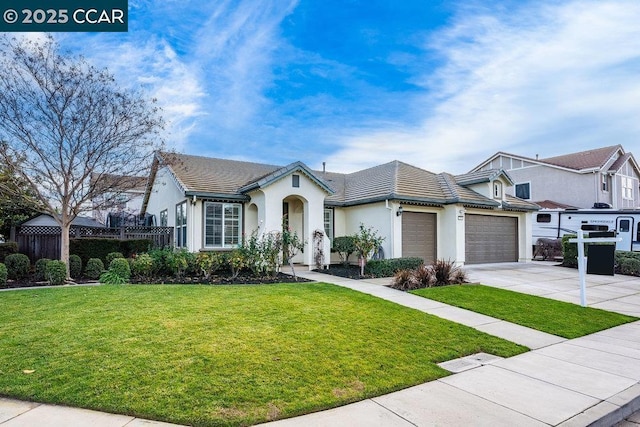 view of front of home with a front lawn and a garage