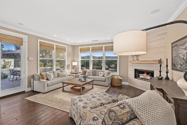 living room featuring dark hardwood / wood-style flooring and crown molding